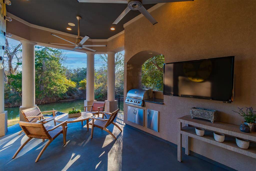 First floor patio with built in grill and television outlets.