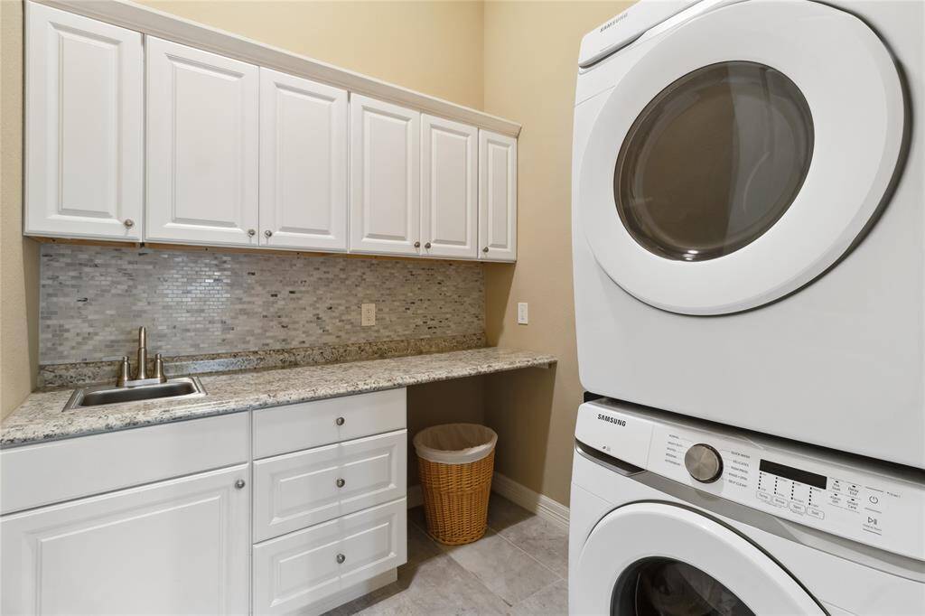 Laundry room enough space to stack or put the washer and dryer side by side.