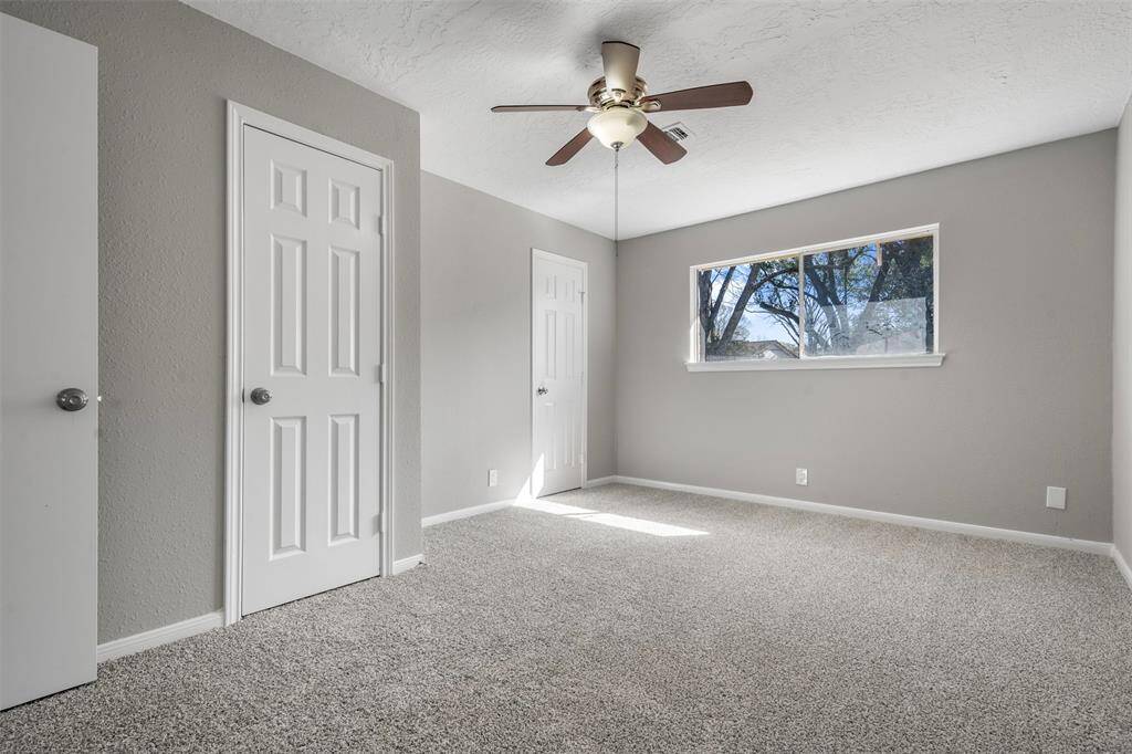 Primary bedroom with new light fixture and new carpet.