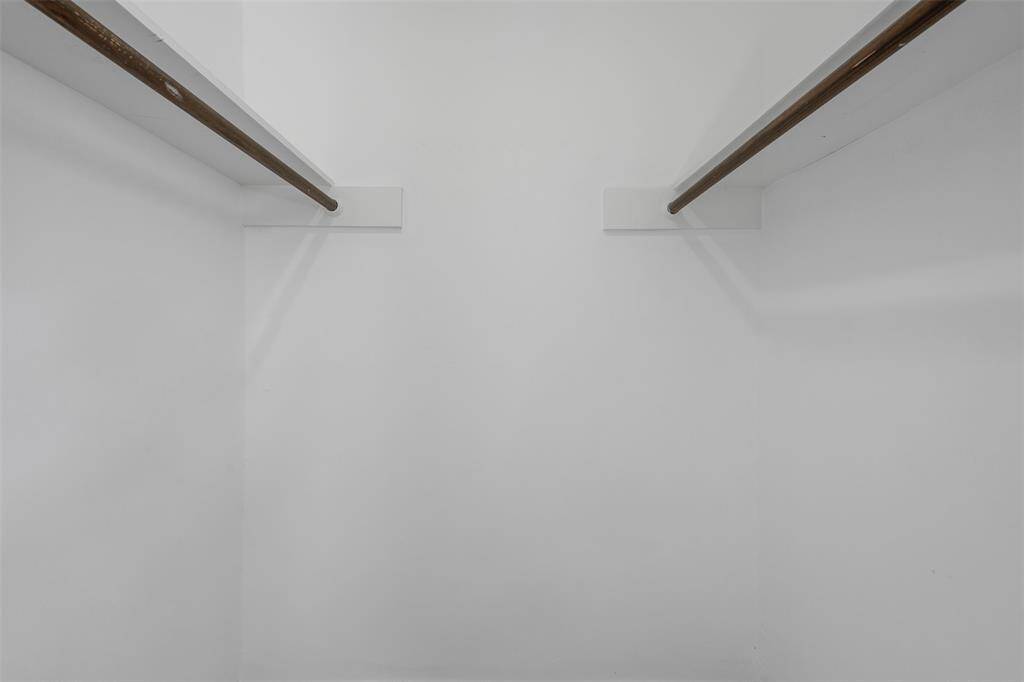 View of primary bedroom walk in closet.
