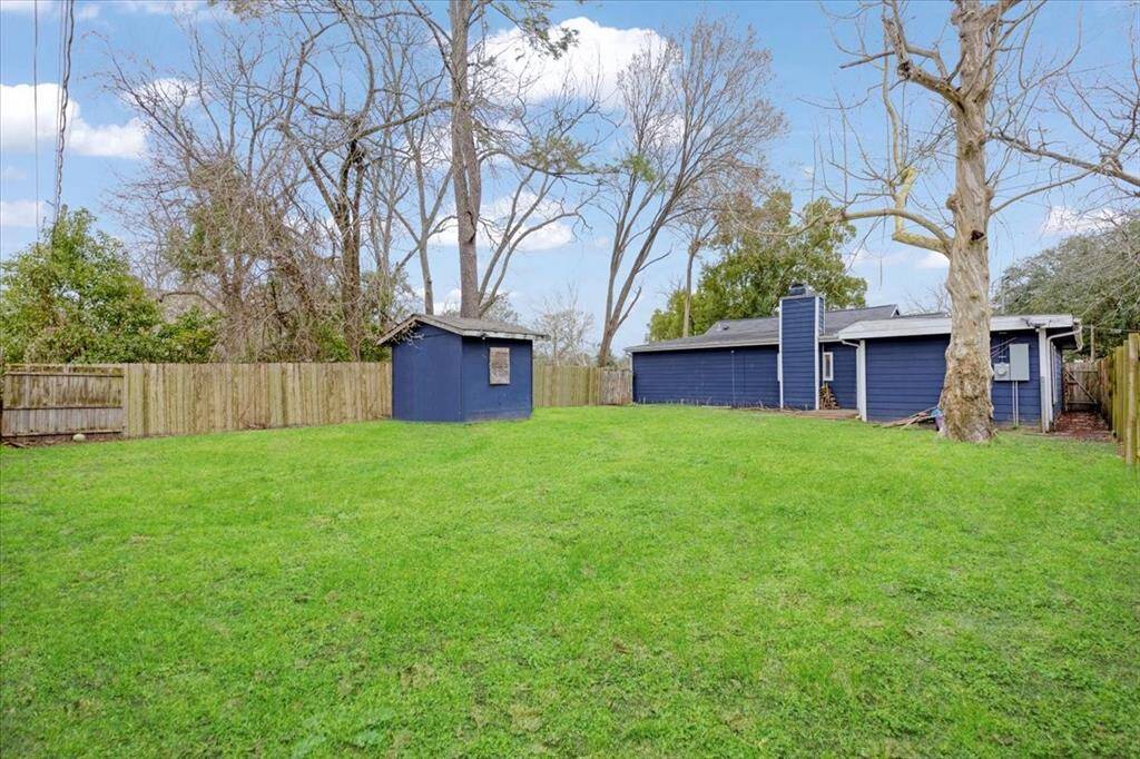 Back yard with storage shed.
