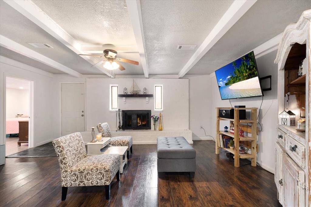 Family room with wood burning fireplace.