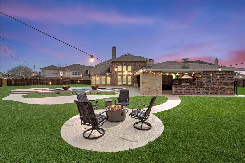 The fire pit offers the ideal setting for relaxing and unwinding by the pool, creating a cozy atmosphere for gathering, conversation, and enjoying the warmth under the stars.