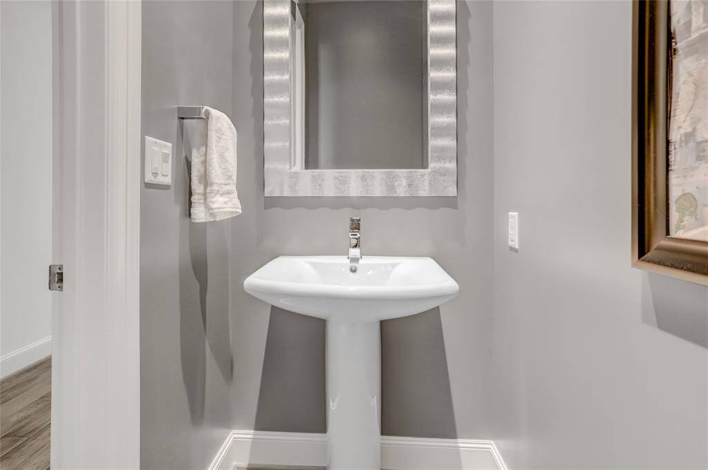 The conveniently located half bath is just off the main entrance, across the hall from the versatile flex room, offering easy access for both residents and guests.