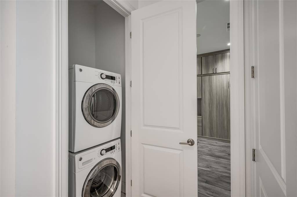 Located next to the flex room for easy access, this stacked washer and dryer set will convey with the sale of the unit.