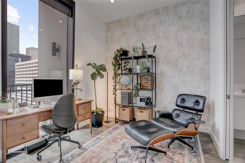 The second bedroom features an ensuite bath and a spacious closet with custom Spaceman cabinetry for optimal organization. It comfortably fits a queen-size bed and offers stunning city views, with blackout shades to ensure privacy and restful evenings.
