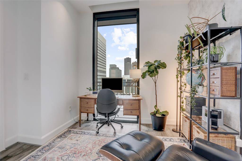 Another view from the secondary bedroom, where the large window allows natural light to pour in, filling the room with warmth and offering fantastic views of downtown. For added comfort and privacy, the window is equipped with blackout shades, ensuring a restful environment at any time of day.