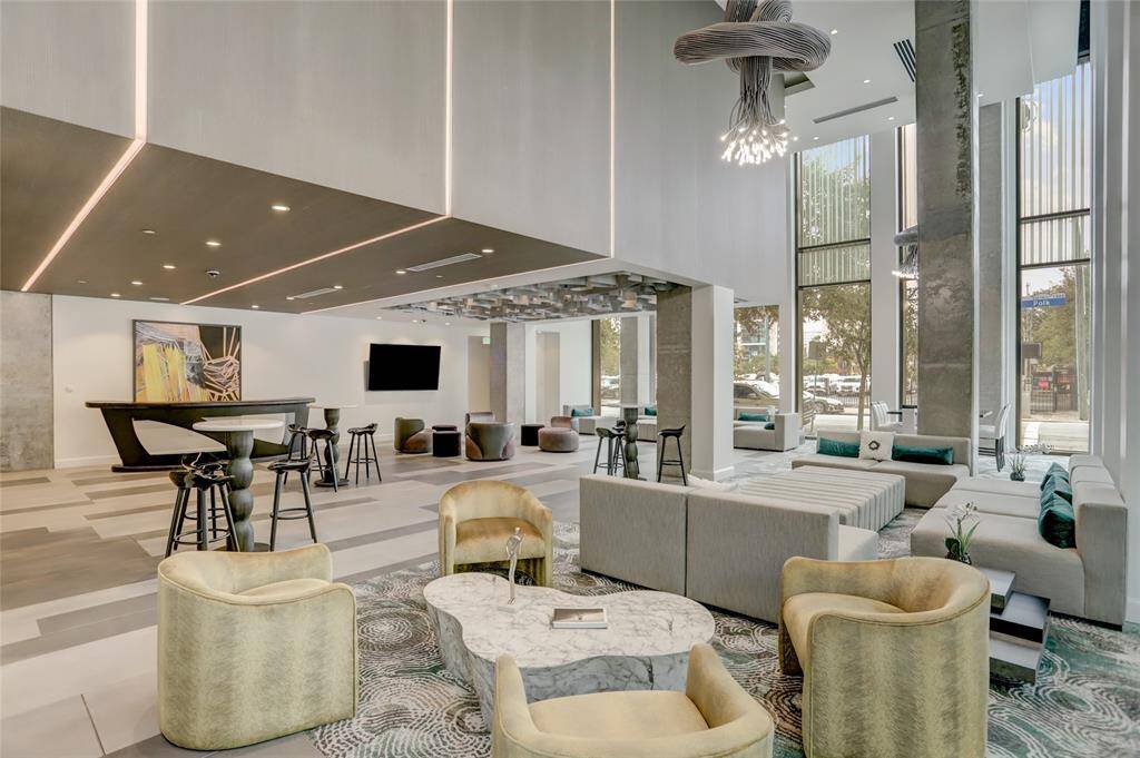 Contemporary lighting fixtures cast a warm glow over polished floors, while sleek architectural details create a refined atmosphere.