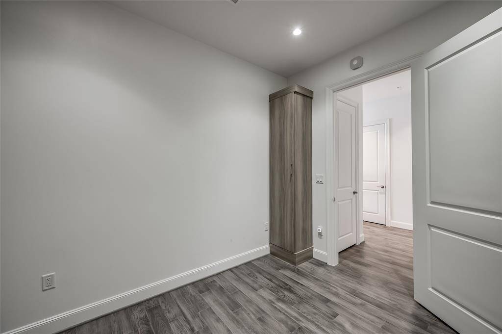 From the opposite view of the flex room, you'll notice a built-in cabinet that offers additional storage space. The open layout flows into the foyer, creating a functional and airy atmosphere.