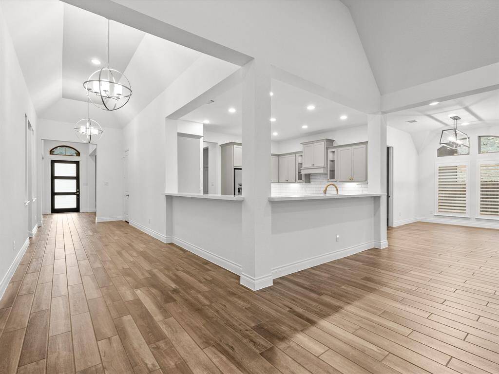 View of Foyer Entry, Kitchen/Bar & Breakfast Room from Family Room.