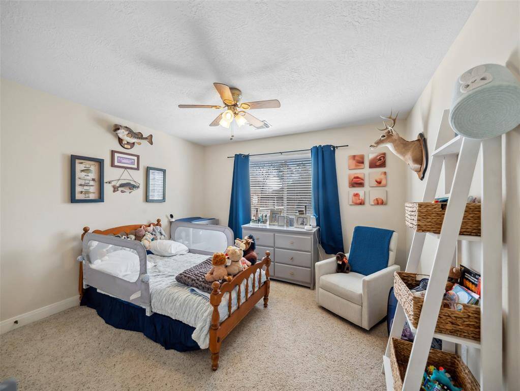 Guest bedroom one has large window overlooking the back yard and double door closet with built ins.