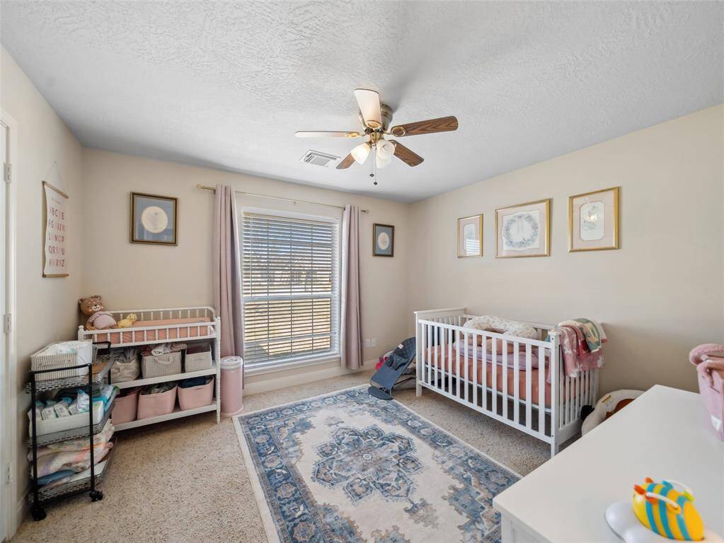 Guest bedroom two also features a large window overlooking the front yard and double door closet with built ins.
