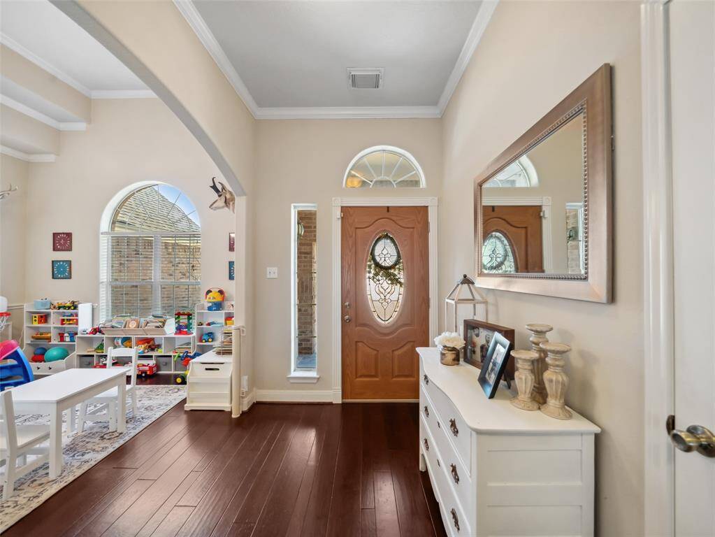 Entry foyer opens to the formal dining room to the left, currently used as a play room.