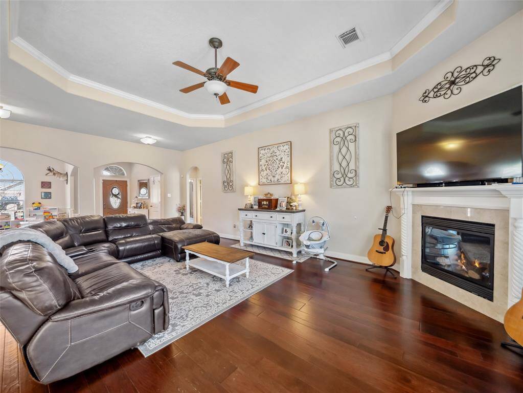 The large living room also opens to the foyer and formal dining room. A corer gas log fireplace adds warmth.