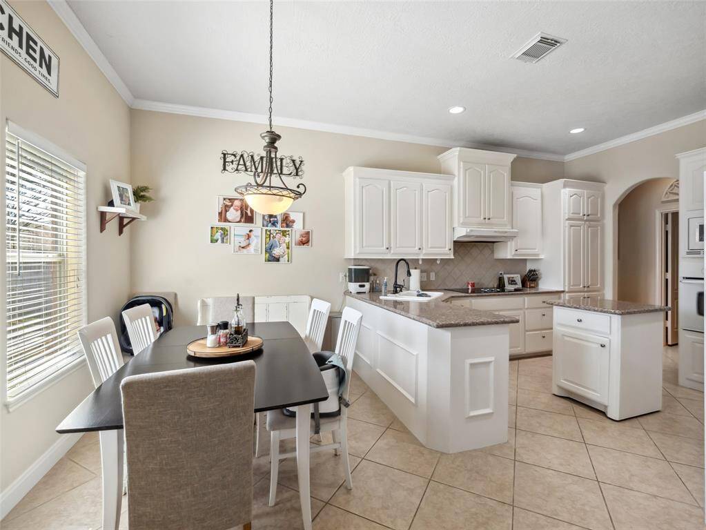 Light and bright breakfast room and kitchen is just off of the living room.