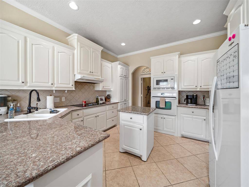 Plenty of counter space and cabinet space in this bright kitchen.