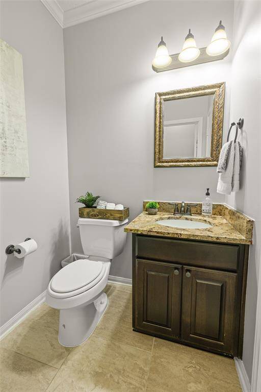 To the left of the Foyer and near the Home Office is a Half Bath, complete with granite counters, oil rubbed bronze fixtures and a HUGE storage closet. Note the crown molding continues throughout the first-floor including the bathroom!