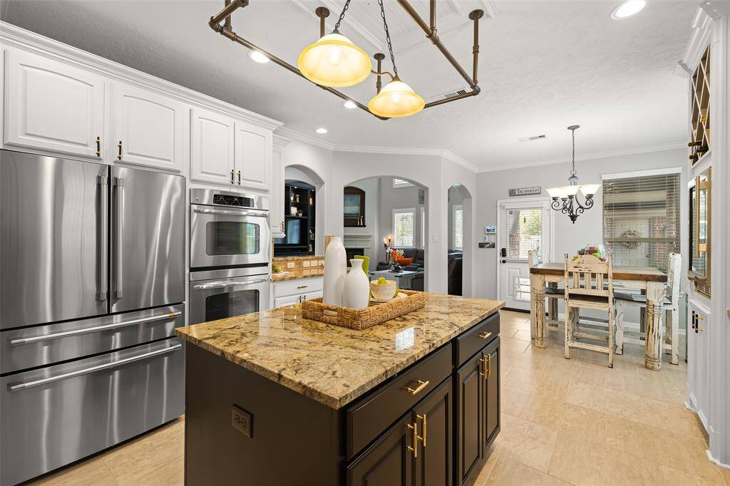 To compliment the unique iron light fixture and Tricor Black painted island, the Homeowner chose black and brushed gold cabinet hardware. It's attention to details such as these, along with crown molding and plantation shutters that make this a special place to call home today, and for years to come.