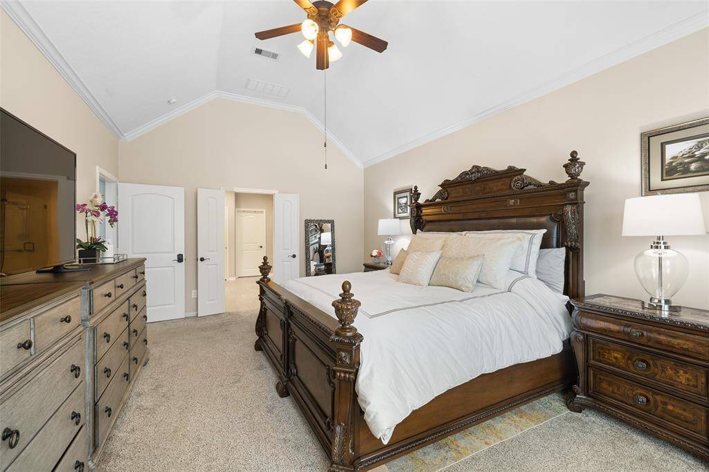 Another view of the spacious Primary Bedroom. The door at the left leads from the Den and offers a keyless entry keypad for privacy and secure storage of personal items, while the door at the back leads to the ensuite.