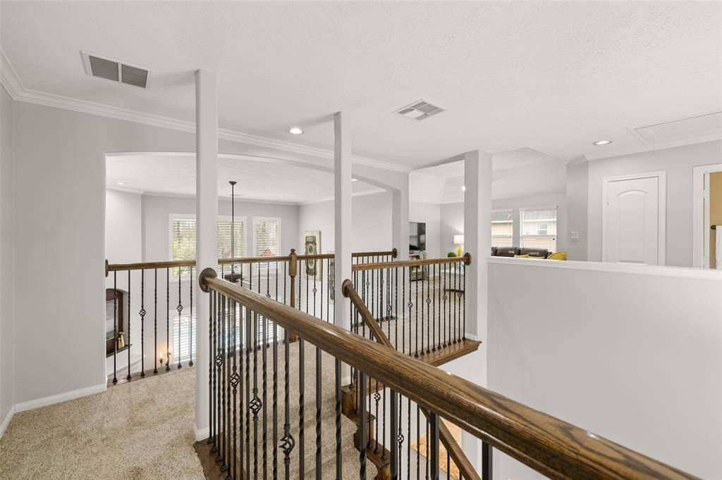 The upstairs Landing also provides a front-to-back view of the home including the Den, front and back yards, pool, Game Room and spacious secondary Bedrooms. The overall feeling is open, spacious, light and bright.