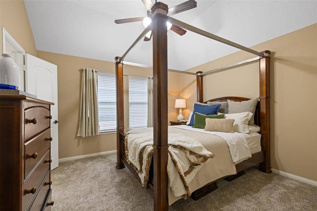 Secondary Bedroom #4 is a great size room for guests, measuring 15’ x 12’ with a soaring 10’ vaulted ceiling, double windows, ceiling fan and soft carpet.