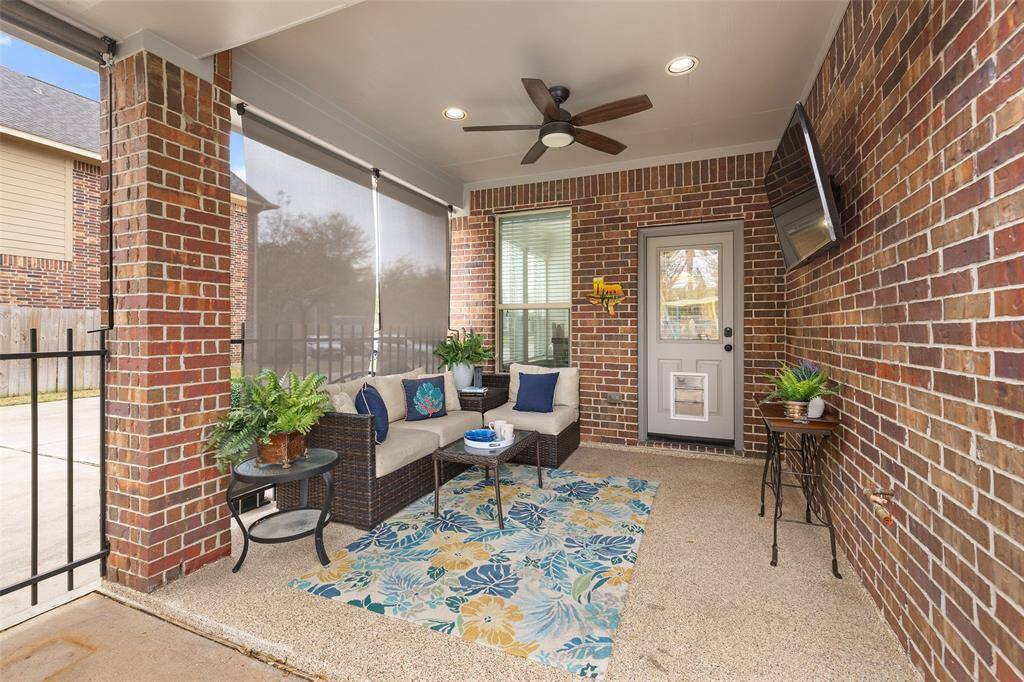 The covered back patio measures 11’ x 10’ and offers an epoxy finished floor, recessed color-changing lights (app controlled), a ceiling fan, privacy shades, tv mount and a natural gas grill connection.
