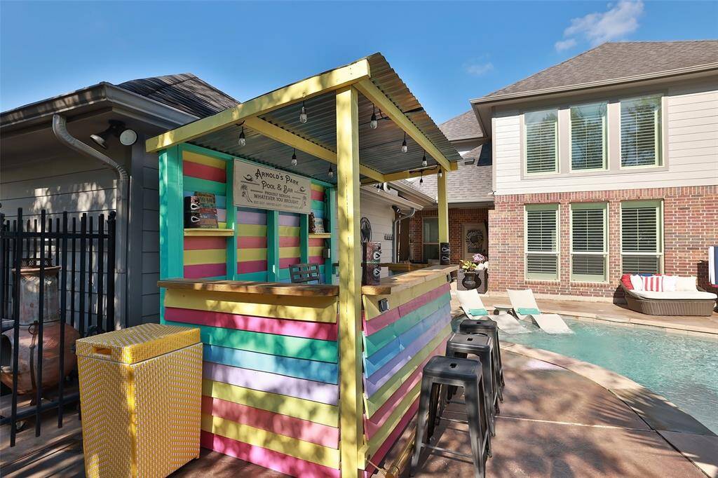 This home - and backyard is designed for entertaining, and nothing says FUN more than your own Tiki Bar! This gathering spot has been a focal point (and major draw) for entertaining neighbors, family and out of town guests. The covered "hut" is outfitted with a deep bar, a brass foot rail, color-changing lights and electrical. Imagine all the good times and memories you'll create in this one-of-a-kind backyard!