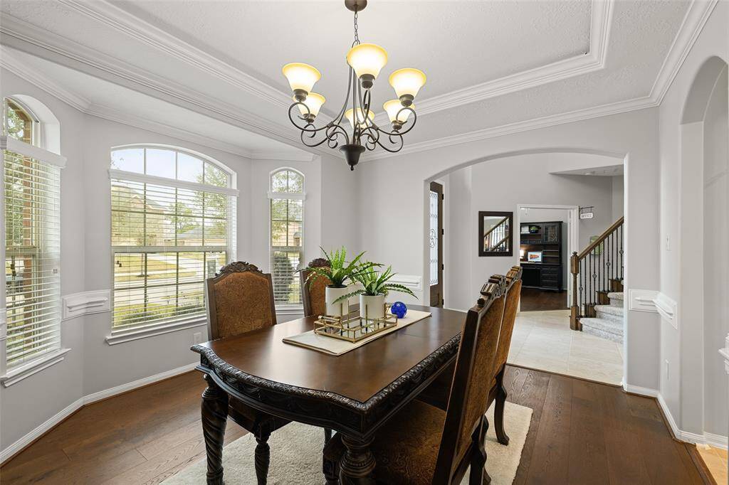This view shows the Dining Room and Home Office flanking the grand Foyer at the front of the home. The Homeowner had the interior painted with one of today's most popular Sherwin Williams colors; Repose Gray. All trim / millwork is classic white with an oil-based paint for long lasting durability and easy maintenance.
