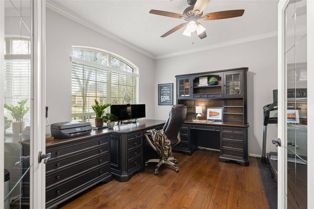 Since we have to work, why not enjoy the experience from the luxury of your home with a peaceful view of the yard. Beautiful crown molding, French glass doors, double-wide windows, storage closet and wide-plank hardwood floors make this a beautiful and comfortable place to be. There is plenty of room for two or use this space as a home gym, playroom, library or billiard room.