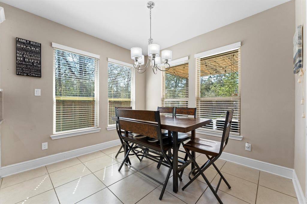 Charming breakfast area with large windows that face the backyard and pool.