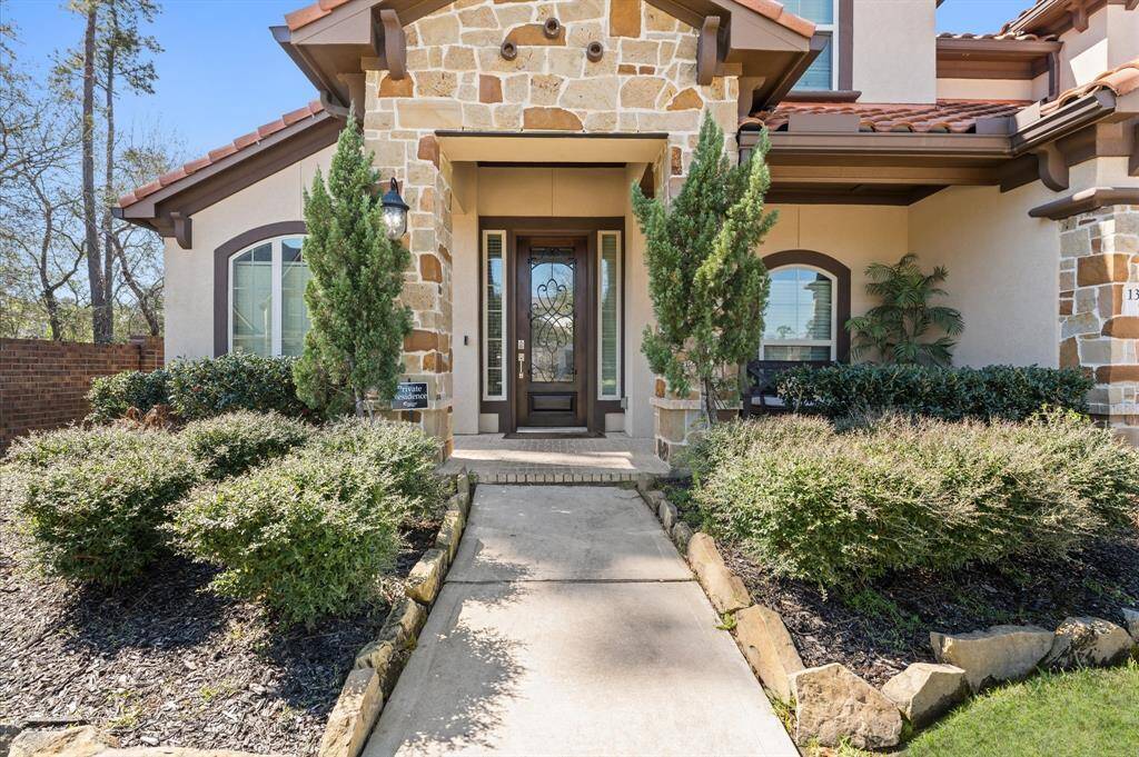 Elegant 8 ft entry door crafted from rich, dark wood, with a large window panel that allows natural light into the home.