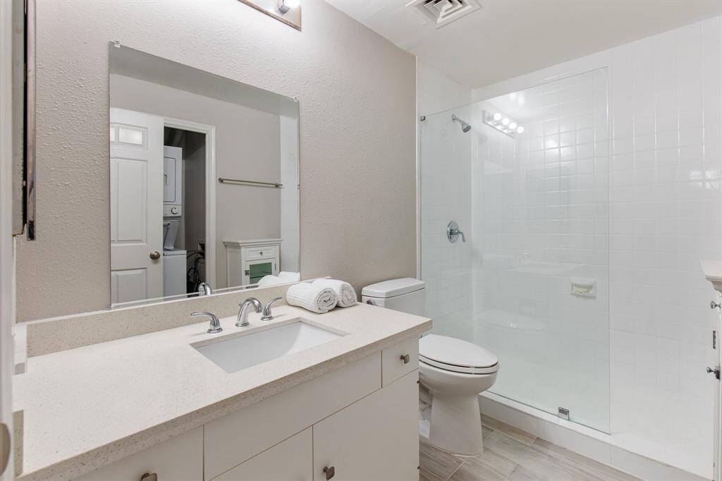 Guest bathroom with Quartz counters and seamless glass shower.