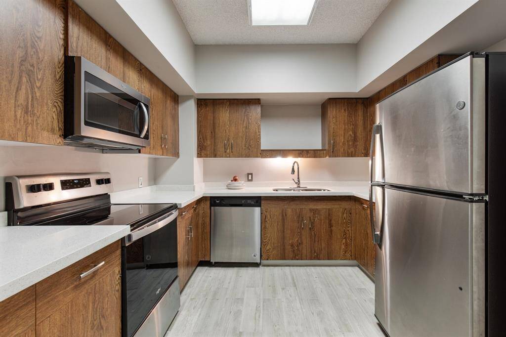Kitchen with Quartz counters and stainless appliances.