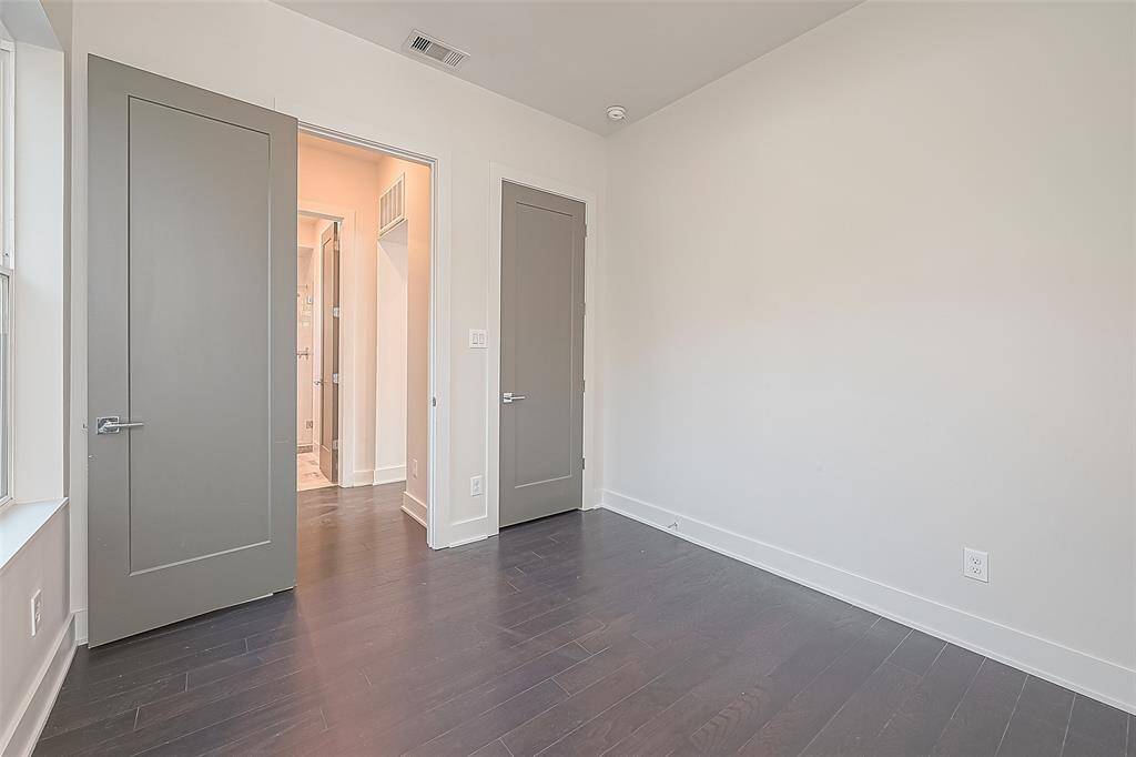 2nd floor bedroom with the closet door to the right and a bathroom across the hallway.
