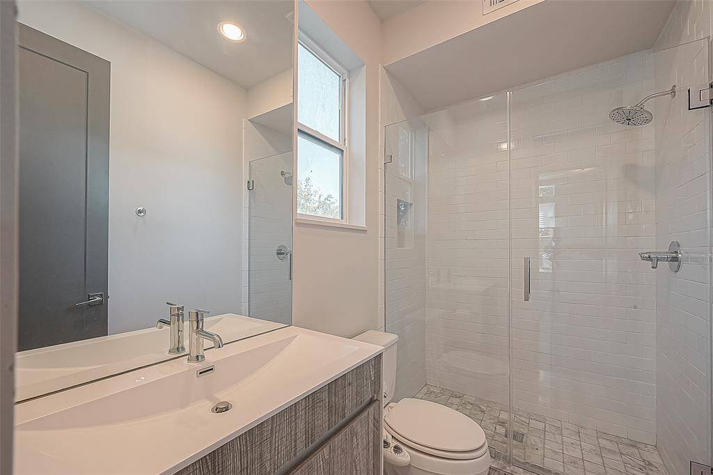 2nd floor bathroom with marble floor tiles in the shower and a closet.