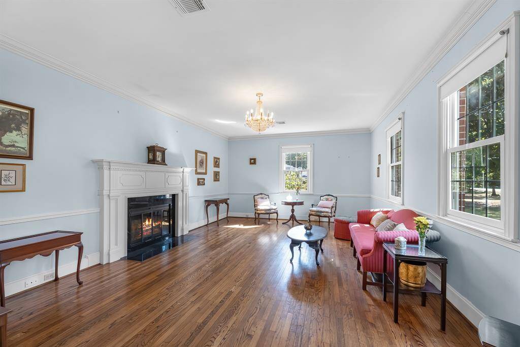 The formal sitting area features wonderful natural lighting and a fire place.
