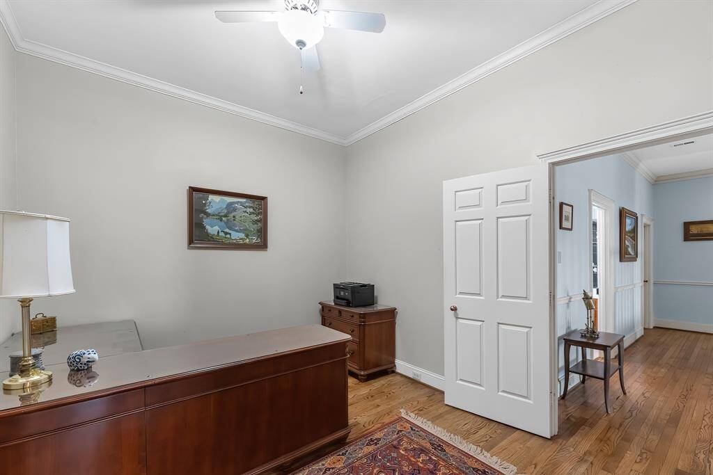 The study features high ceilings and hardwood flooring