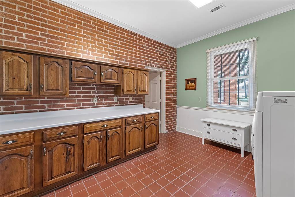 Utility room features plenty of cabinets and counter space