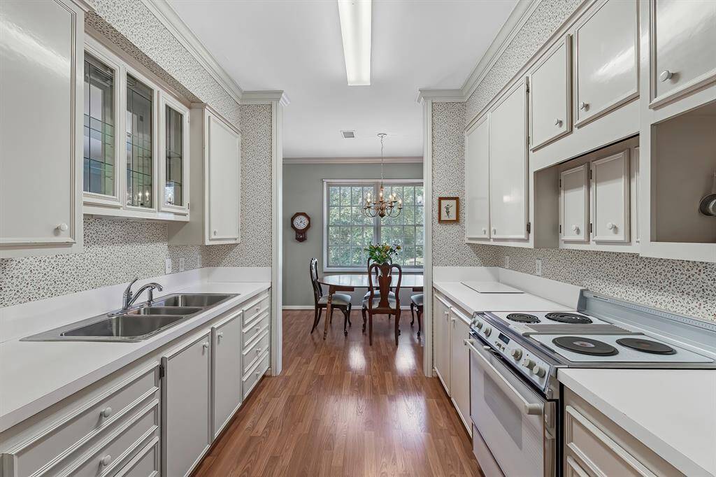Kitchen has custom cabinetry and plenty of counter space