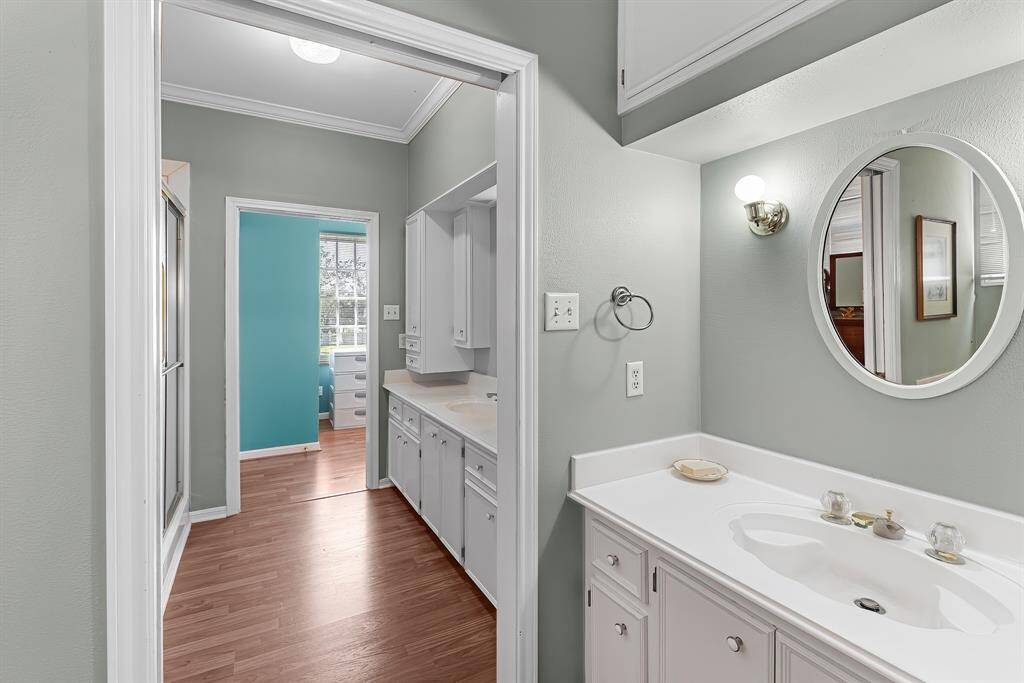 Bathroom with 2 separate vanities and a door to separate fpr privacy,