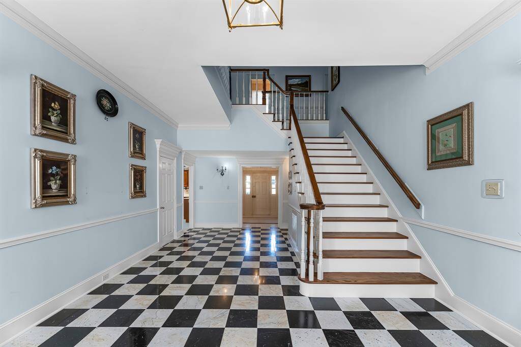 The entry has so much charm with the black and white tiles.