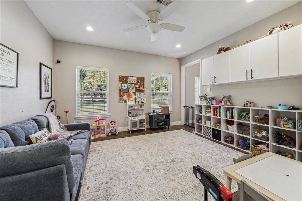 This versatile downstairs room, currently a playroom, can easily transform into an office or extra bedroom.