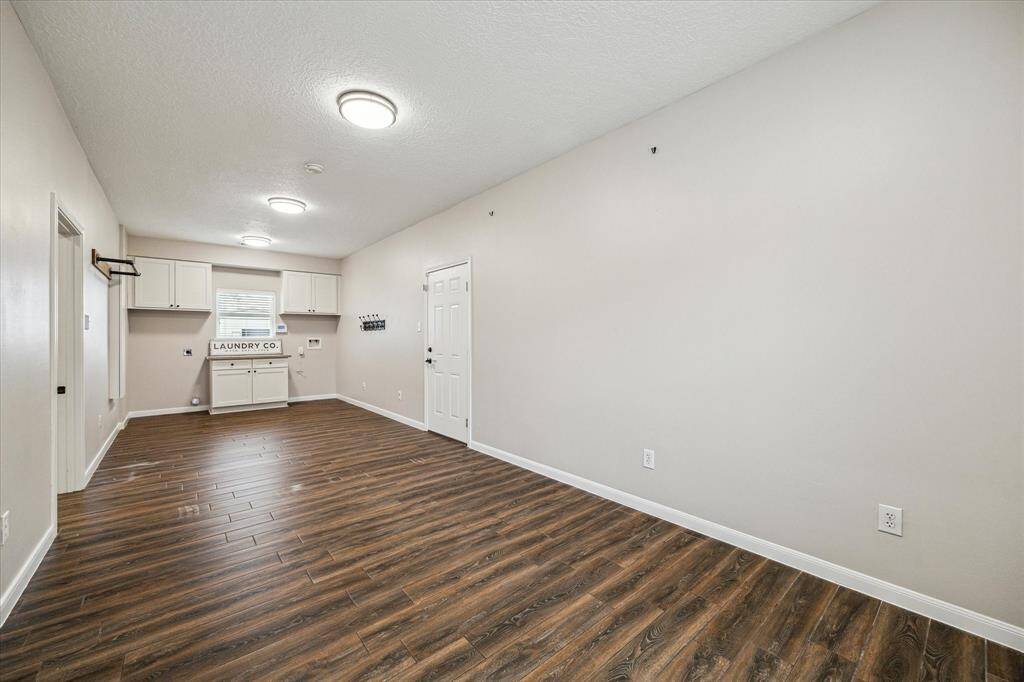 This spacious laundry room offers versatility as well, with potential to create an additional flex space.