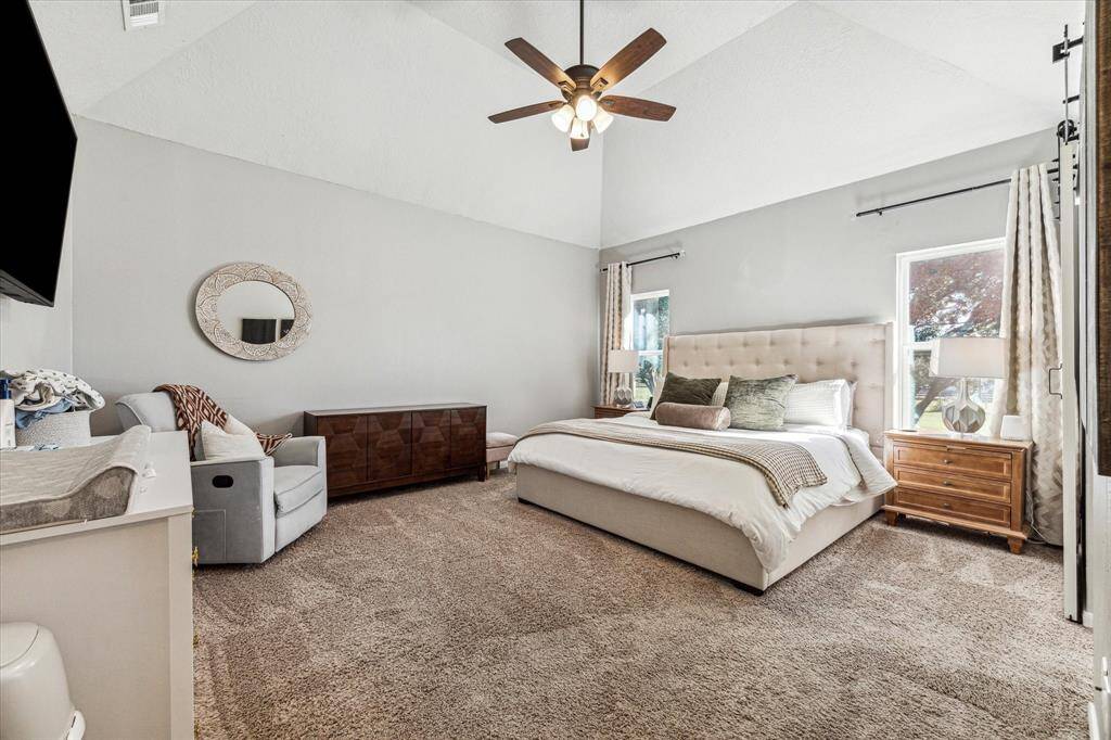The upstairs primary bedroom boasts a cozy wood-burning fireplace and a chic barn door leading to your dual master closets and a beautifully remodeled en-suite bathroom.