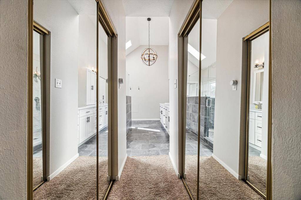 Spacious dual walk-in closets are on either side of the hallway leading to the primary bath.
