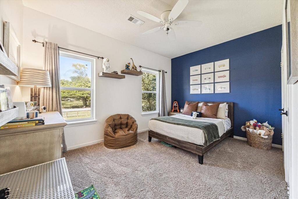 Bright upstairs bedroom with front yard views and abundant natural light.