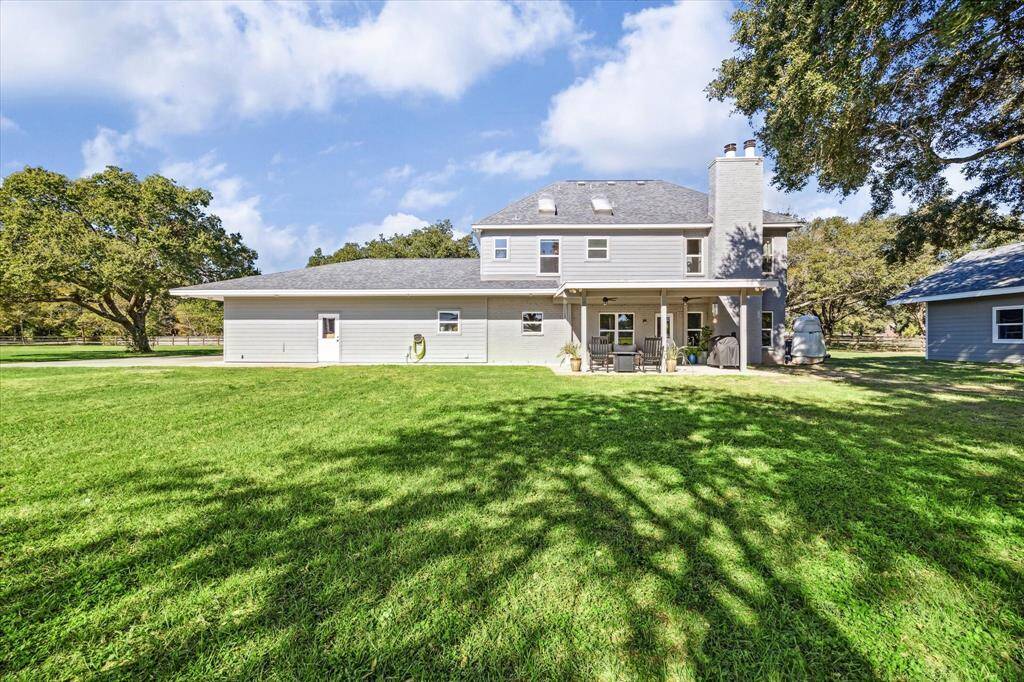 The back features a covered patio, ideal for enjoying your morning coffee or watching the sunset.