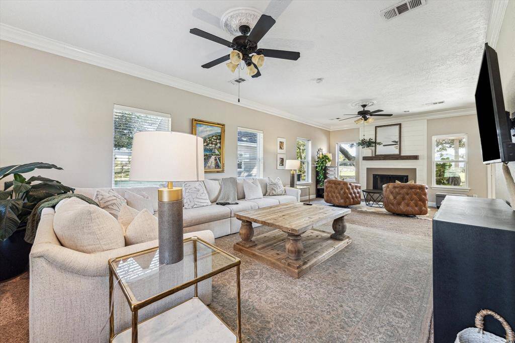 This inviting living room features a cozy wood-burning fireplace and ample seating.