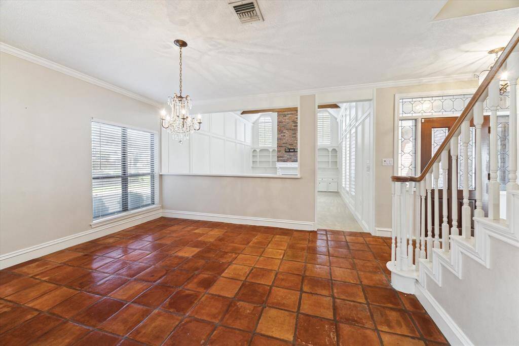 The lovely  formal dining room has crown molding, tile floors and is steps away from the kichen and theliving room.