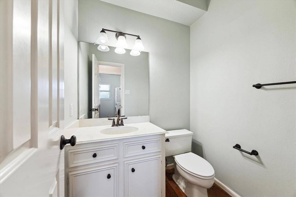 The downstairs powder room is conveniently located off of the kitchen and breakfast room and is tastefully done.